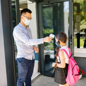 man checking a student s body temperature