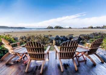 four brown adirondack chairs on porch
