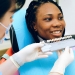 smiling ethnic lady visiting dentist in modern clinic