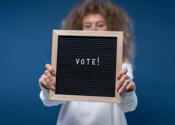 person holding a vote sign