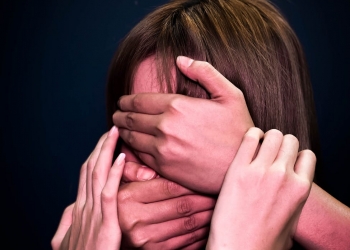 people covering face and mouth of helpless woman