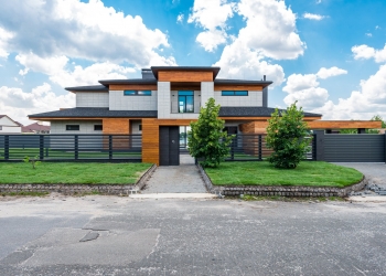 exterior of fenced modern villa in suburb area