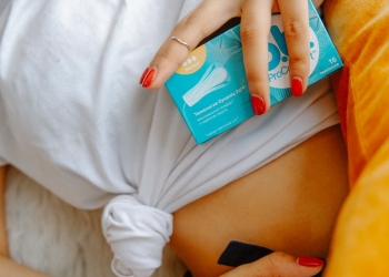 woman holding box of tampons