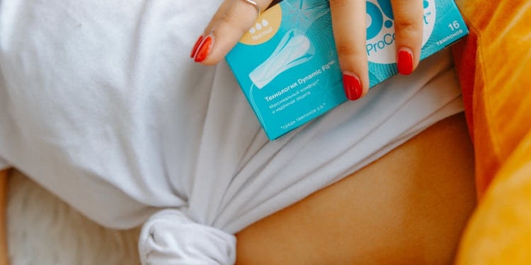 woman holding box of tampons