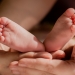 person holding babys feet