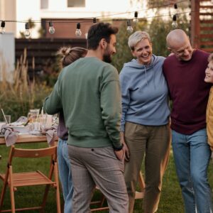 man in red sweater standing beside man in gray sweater