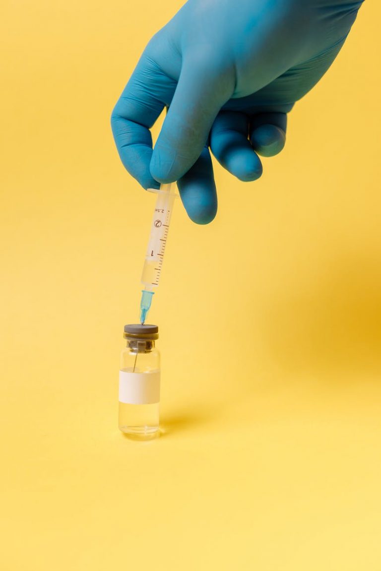 covid vaccine on yellow surface