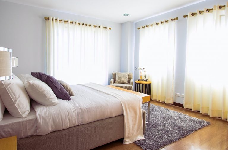 white bed comforter during daytime