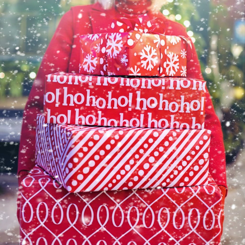 woman carrying christmas gifts
