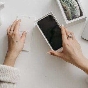 a person holding a phone in the box