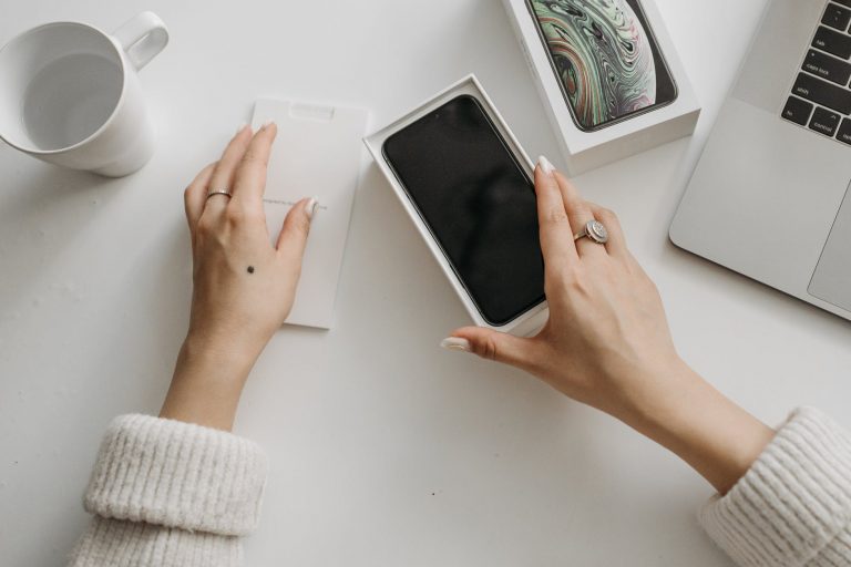 a person holding a phone in the box