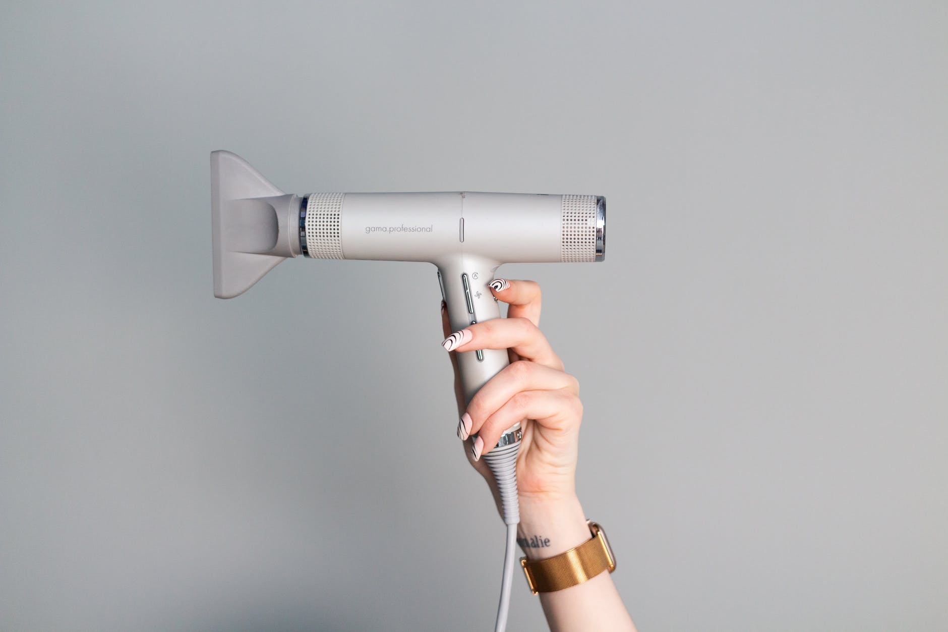 close up shot of a person holding a blow dryer