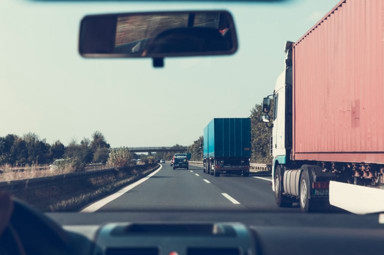 blue and red freight truck on road