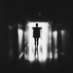 monochrome photo of person standing on hallway