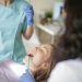 unrecognizable female dentist with assistant preparing for inspecting patient teeth