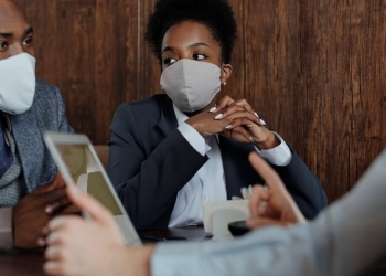 business people wearing face masks and talking