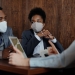 business people wearing face masks and talking