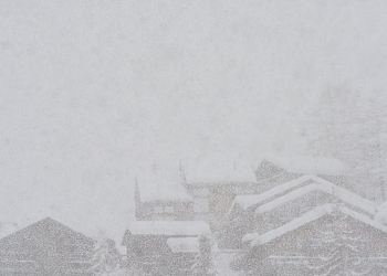 rural snowy village during severe blizzard