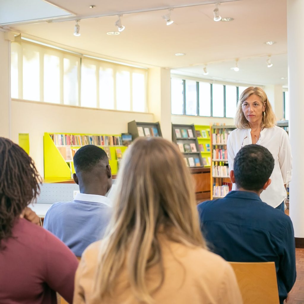 multiethnic students listening lecturer in university