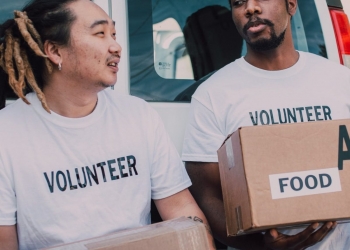 men in crew neck shirt carrying boxes