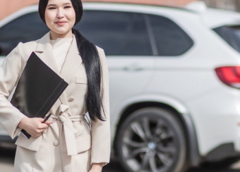 woman in beige corporate clothes holding black folder