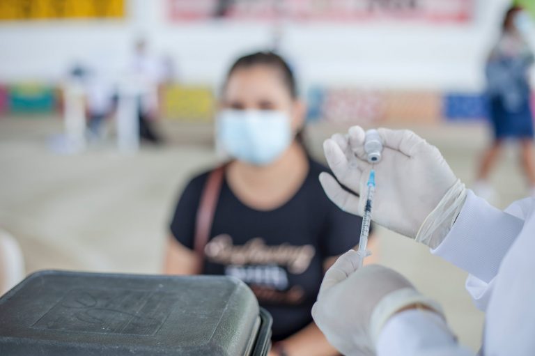 a person holding a syringe