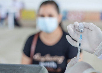 a person holding a syringe