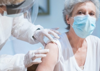 an elderly woman getting a vaccine