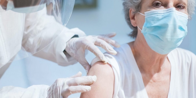 an elderly woman getting a vaccine