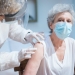 an elderly woman getting a vaccine