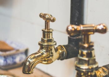 close up photo of golden faucets