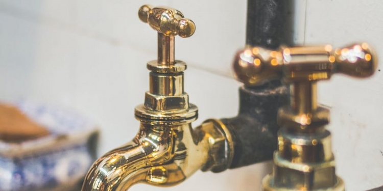 close up photo of golden faucets