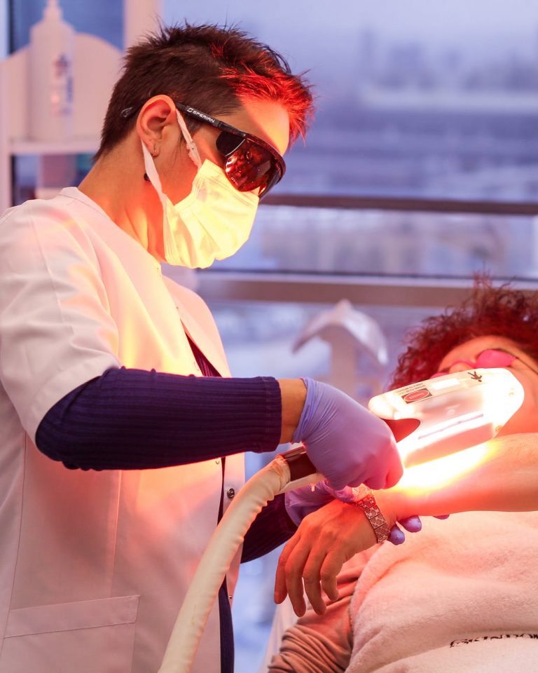woman giving laser treatment