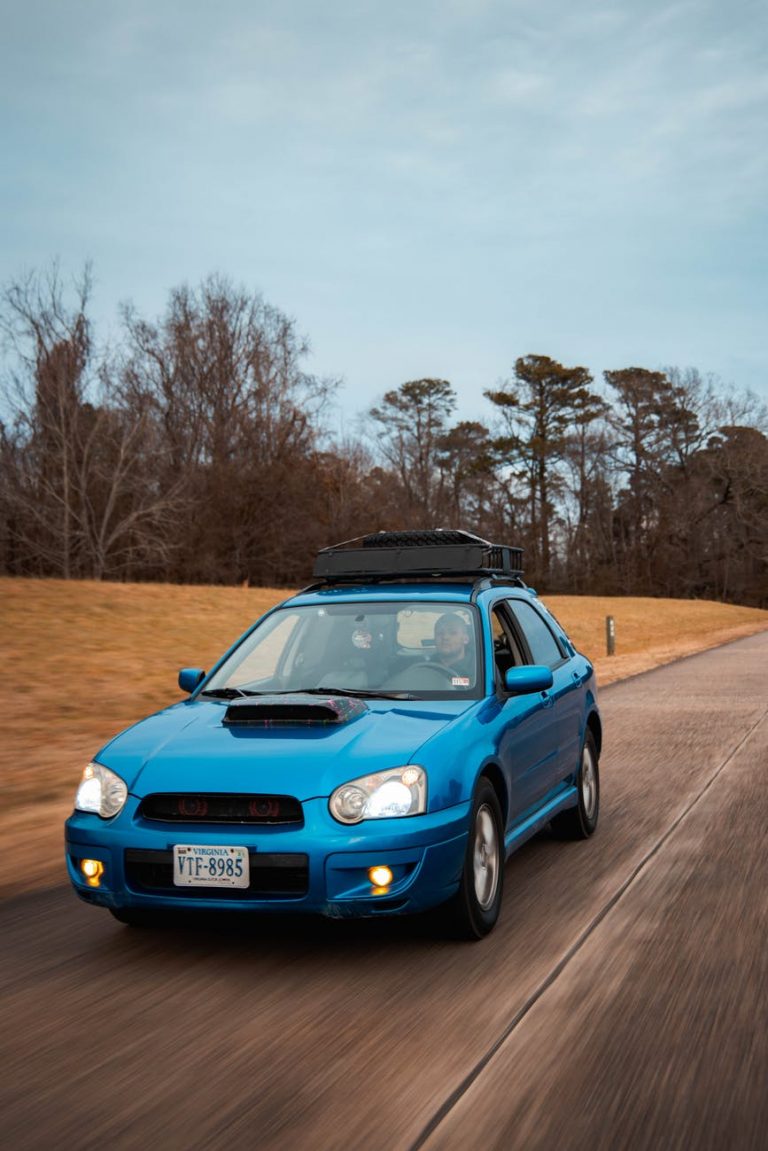 a person driving a blue car