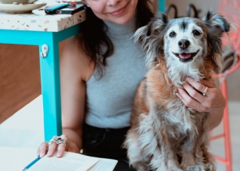 a woman holding her pet dog