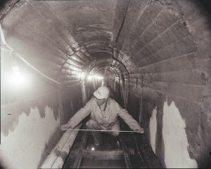 Sewers_02_1967-12-28_Bernard Julien_measures Water St riverfront interceptor sewer near Horovitz Park