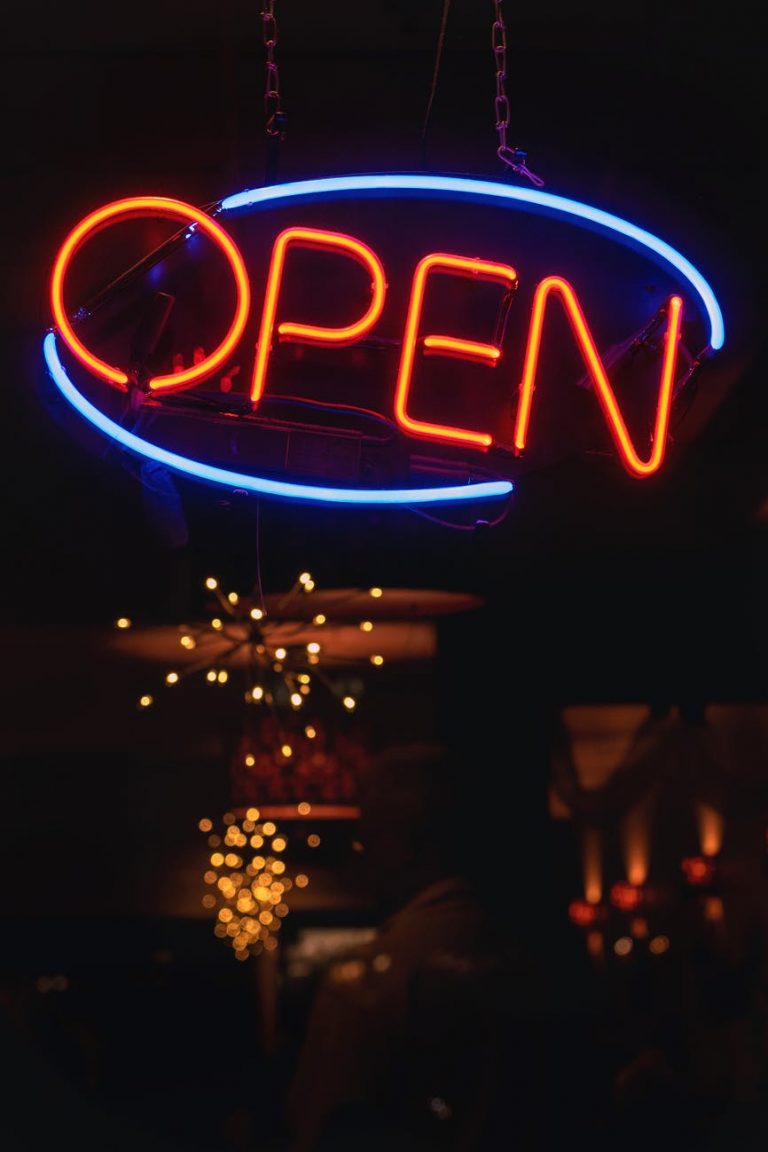 oval blue and orange open neon signage turned on