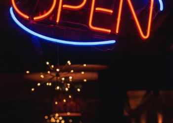 oval blue and orange open neon signage turned on