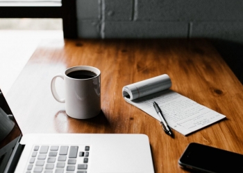 macbook pro on brown wooden table