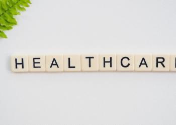 healthcare text screenshot near green fern leaf