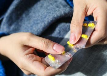 person holding blister pack