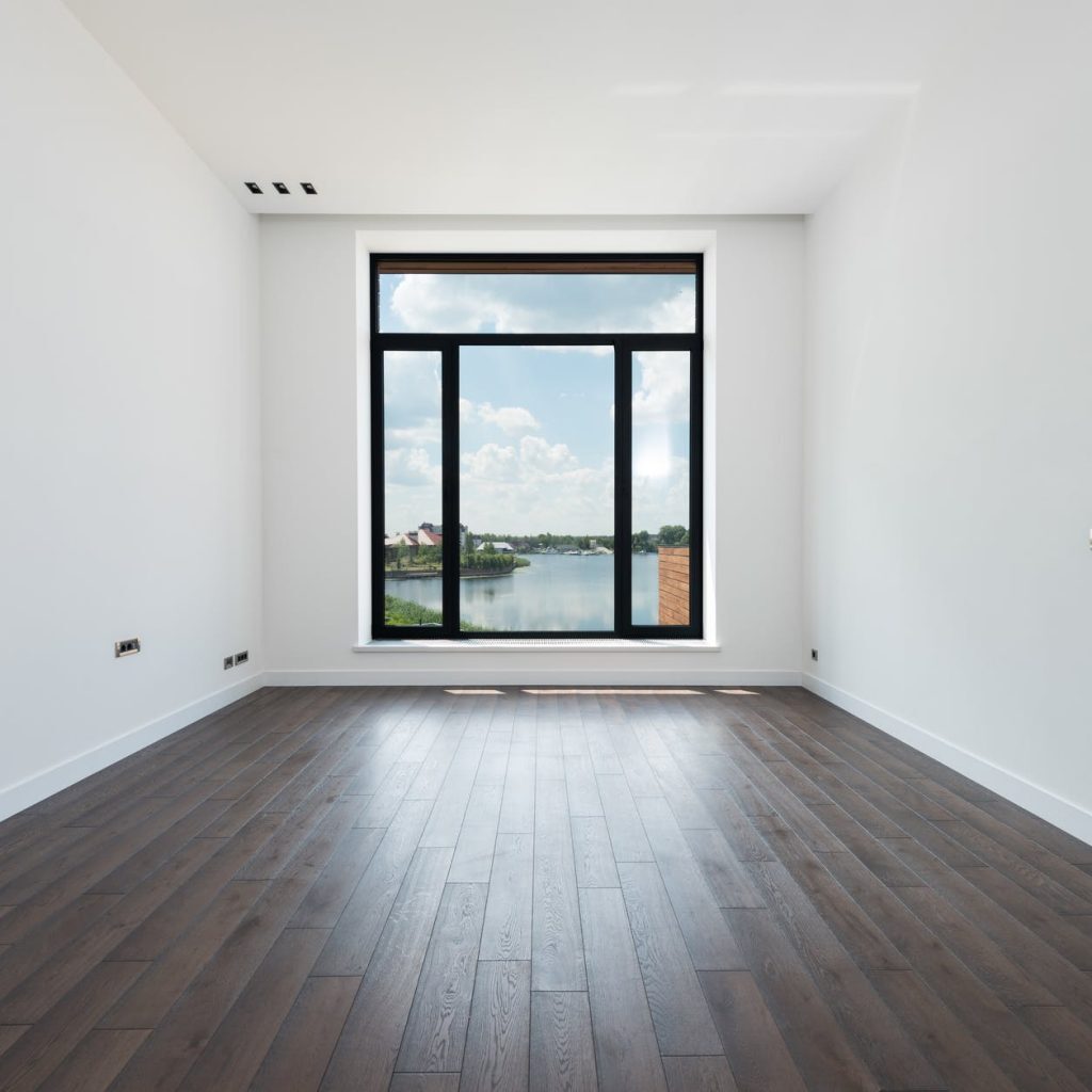spacious room with white walls and panoramic windows