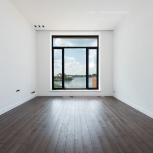 spacious room with white walls and panoramic windows