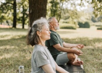 elderly people meditating in the park