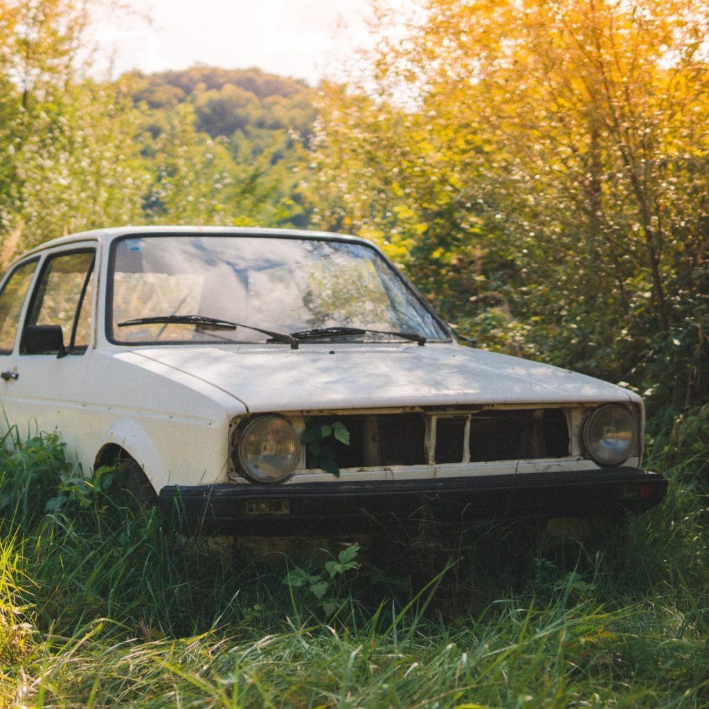 abandoned white car on the grass