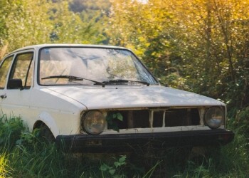 abandoned white car on the grass