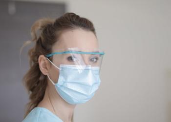 woman in blue shirt wearing face mask