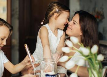 photo of woman playing with her children