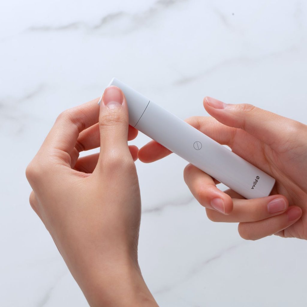 a person holding a vape pod