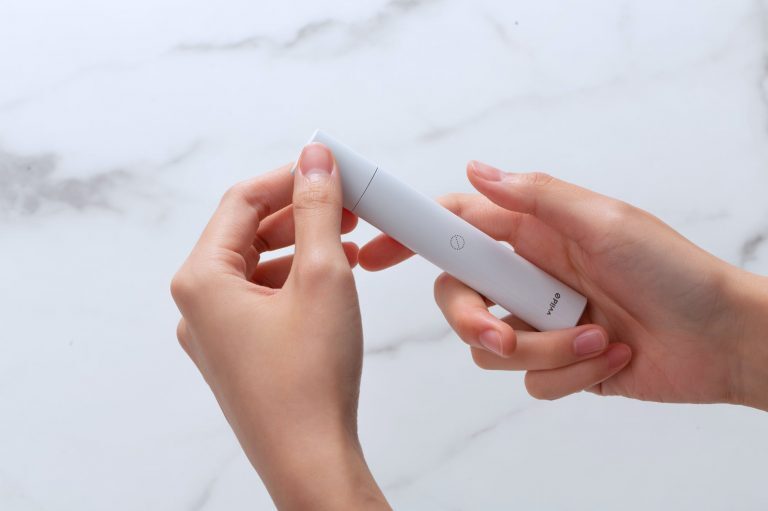 a person holding a vape pod